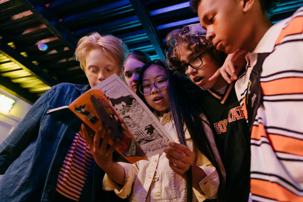 Kids excitedly looking at a comic book