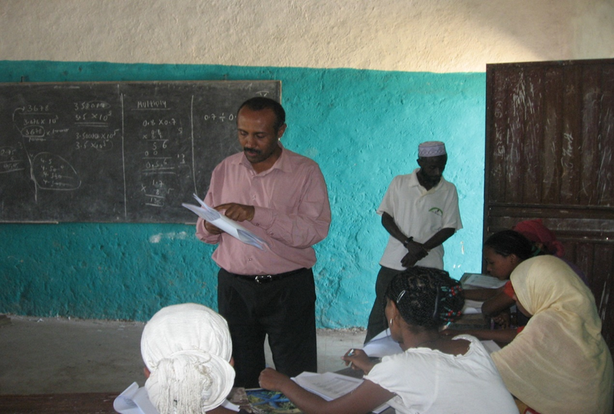 Man explaining a survey in an Ethiopian classroom.