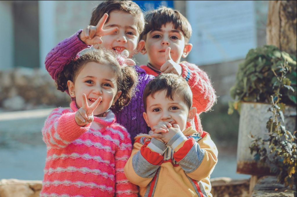 four kids posing for the camera