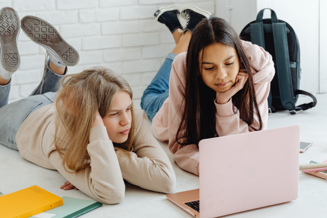 Picture of two girls in front of a laptop.