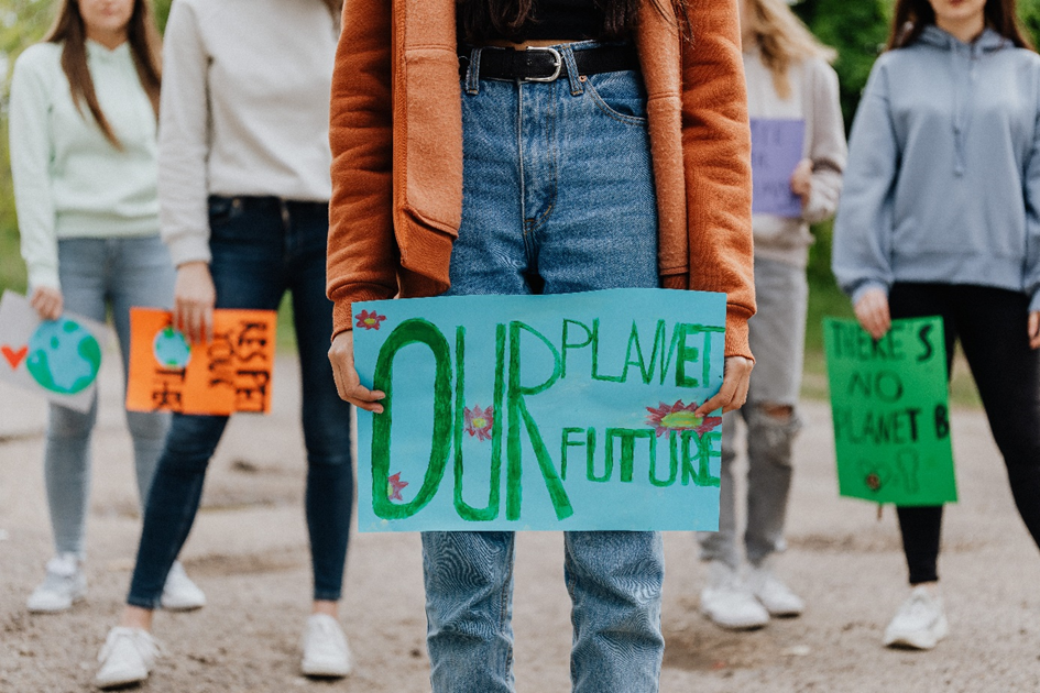 Young people holding signs saying "our planet our future" and "there is no planet B".