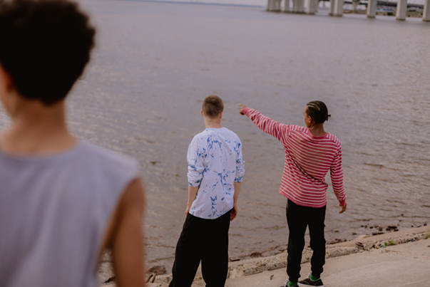 three young man by the beach