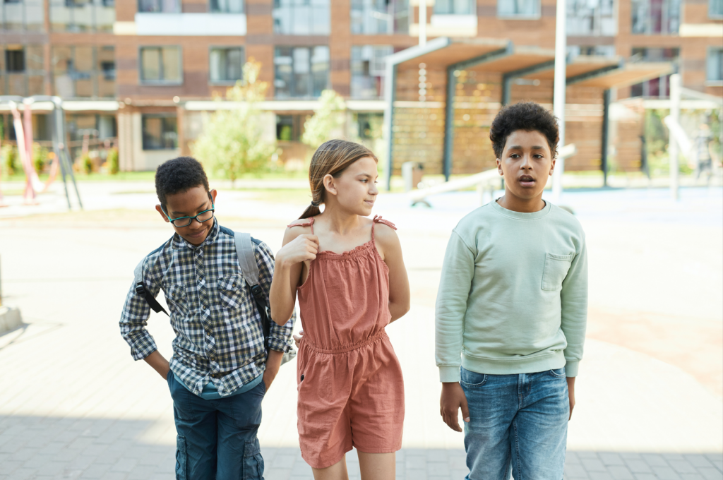 Picture of three kids in a schoolyard