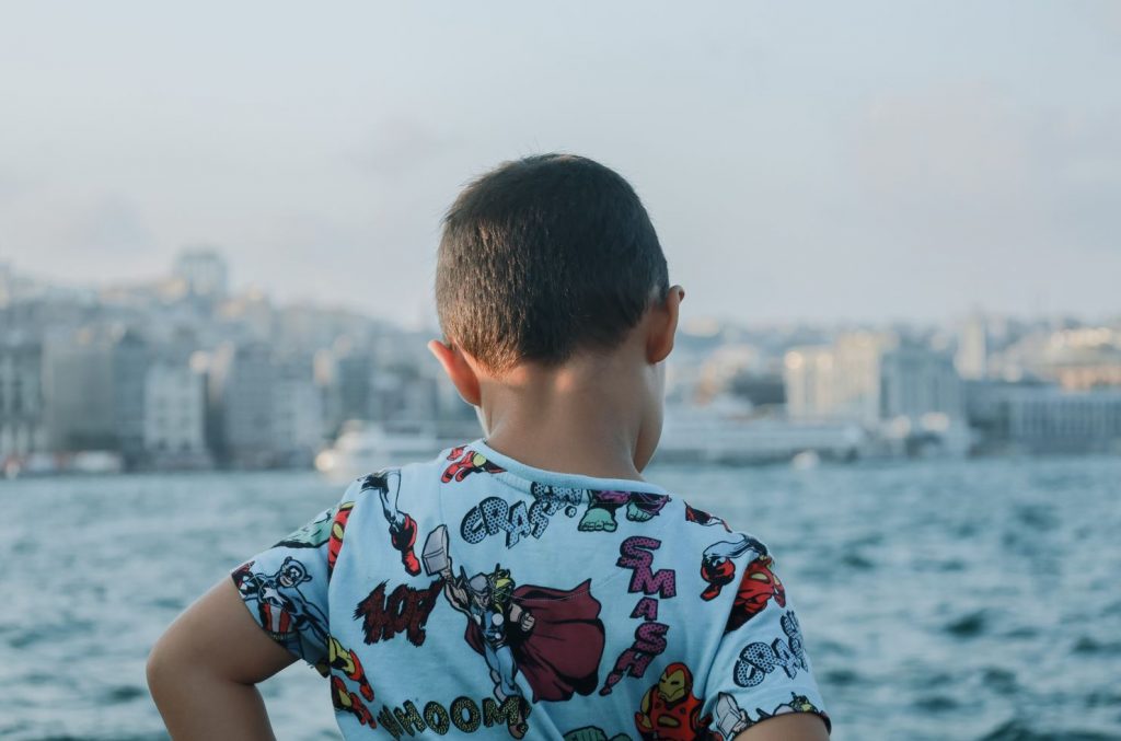 Picture from a boy overlooking a city and an ocean.
