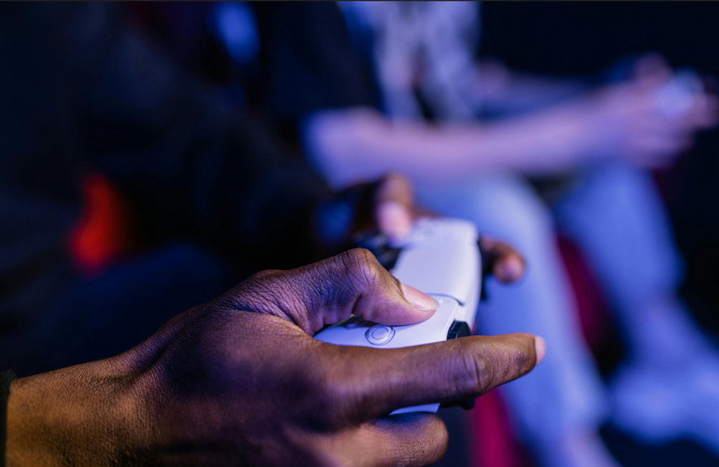 hands holding a controller for a video game