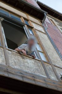 man looking out of a window