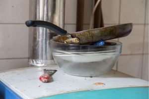 bowl with plates inside and a pan on top