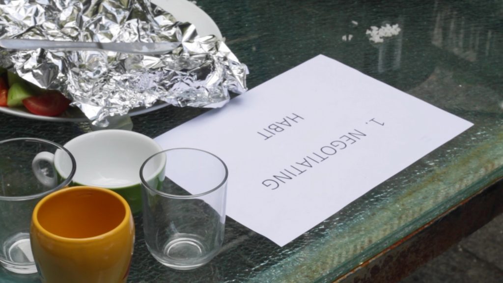 Empty glasses, food covered in tin foil and a sign on a table. Credit: Nick Polson