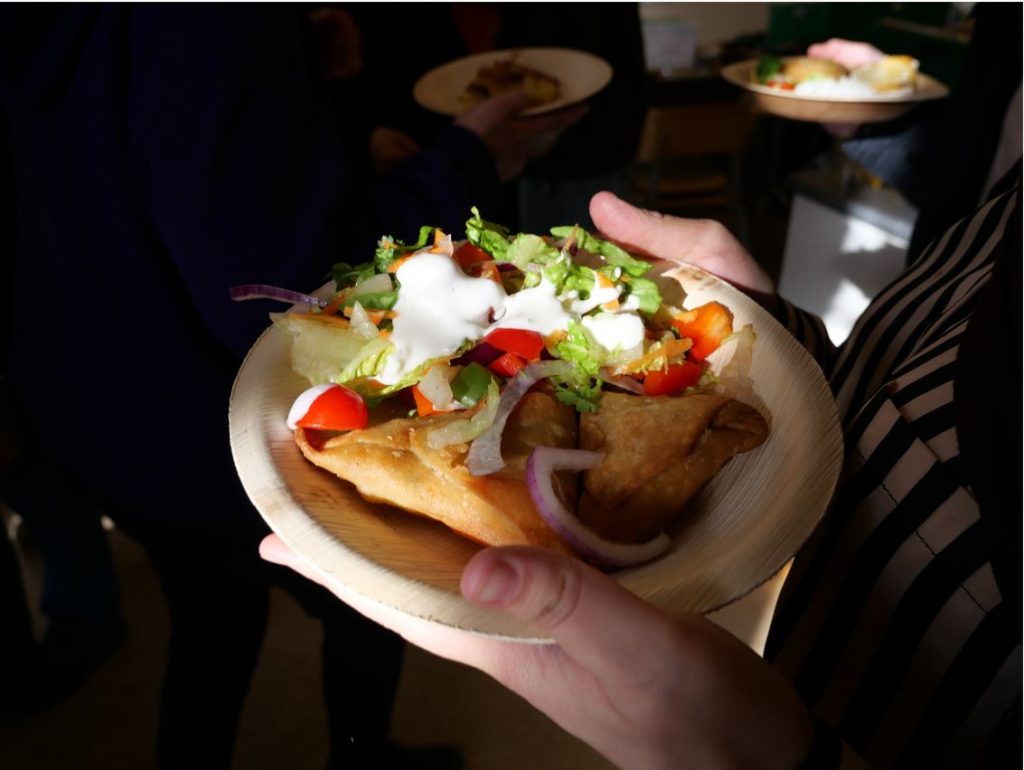 Plate with surplus food at a surplus table.