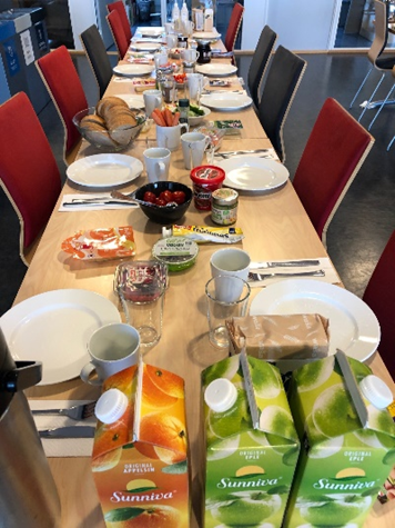 Table with plates and lunch food.