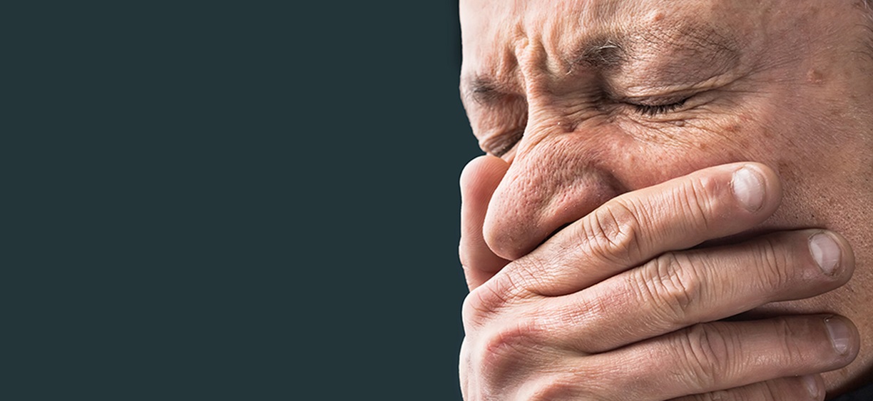 Toothache. Portrait of an elderly man with face closed by hand on dark background. Colourbox